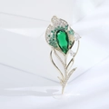 Exquisite golden tulip brooch featuring a teardrop green gem and pave crystals - Green