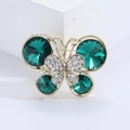 Elegante spilla a farfalla con cristalli verde smeraldo e diamanti su base dorata - Verde