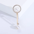 Elegant gold key brooch with pearls and rhinestones on white minimalist background - Gold