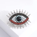 Detail view of Evil Eye brooch with blue beads, black gemstone and silver rhinestones - Silver