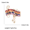 Golden musical staff brooch with colorful enamel and swinging musical note pendant - Colorful