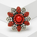 Vintage bohemian flower ring in antique gold with red rhinestones on white pedestal - Red