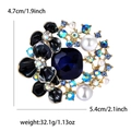Luxurious flower brooch with blue square crystal and pearls in gold-tone alloy - Blue