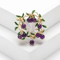 Elegant cranberry brooch with purple berries, green enamel leaves, and gold vines - Purple
