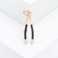 Gold dental forceps brooch with black enamel handle and zircon on white pedestal - Gold