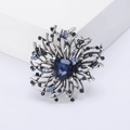 Vintage alloy flower brooch with deep blue crystal and aurora small diamonds on white stand - Blue