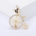 Elegante spilla ape su bicicletta con strass luccicanti e finitura smalto - Nero