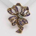 Macro-opname van de vintage strikbroche met donkerblauwe strass en antieke gouden afwerking - Blauw (MM-BR-3669-BL)
