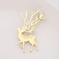 Detail shot of golden elk deer brooch with hollow dots and branching antlers decor - Gold