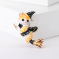 Detail of creative enamel cat brooch wearing a witch hat riding a golden broomstick - Yellow Magic Cat / Yellow