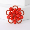 Dettaglio di un'elegante spilla a fiore rosso con montatura in lega dorata - Rosso