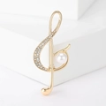 Elegant gold musical note brooch with pearls and rhinestones on minimalist stand - Gold