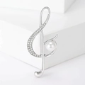Elegant silver treble clef brooch with shimmering rhinestones and a white pearl accent - Silver