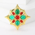 Achtzackige Sternbrosche mit roten und grünen Kristallen auf Goldbasis, eleganter Schmuck - Grün und Rot