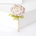 Detailed view of enamel hydrangea brooch with pink crystals and golden stem on white - White