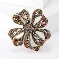Vintage gold bow brooch with colorful crystals and intricate hollow carved patterns - Multicolor (MM-BR-Multicolor-3798-MX)