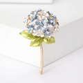 Detail of blue and white enamel hydrangea brooch with crystals on a white podium - Blue