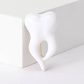 Detail view of a white crown tooth brooch with a polished gold metal pin back - Gold Style (MM-BR-3923-GD)