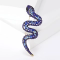 Vista dettagliata di una spilla a serpente con strass blu su un podio bianco - Blu