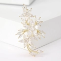 Close-up of golden crystal plum blossom brooch with marquise zircon stones and micro-inlay - Gold
