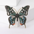 Detail van vintage vlinderbroche met kleurrijke strasstenen en een gouden legering - Donkergroen Veelkleurig