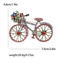 Funkelnde Vintage-Fahrradbrosche mit bunten Kristallen und Emaille-Blumenkorb-Detail - Rosa