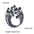 Eleganter Wirbel-Brosche mit tiefblauen Kristallen und Strasssteinen auf Schwarznickel - Blau 3653-BL