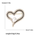 Elegante spilla a forma di cuore con strass bianchi, smalto nero e una perla centrale - Oro