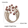 Funkelnde geschwungene Brosche mit rosa und lila Strasssteinen in Goldoptik - Lila 3653-PU