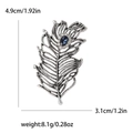 Vintage zilveren verenspeld met blauwe edelsteen en afmetingen 4,9 cm bij 3,1 cm - Zilver