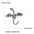 Blue and black enamel dragon brooch with inlaid crystals on white background - Blue