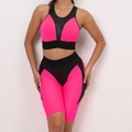 Detail view of pink and black two-piece yoga set with mesh fabric and elastic shorts - S / Top And Bottom / Fluorescent Pink