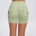 High-waist scrunch butt cargo yoga shorts for women in light green with side button pockets - Avocado Green