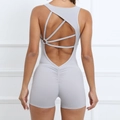 Light gray ruched yoga bodysuit with cross back straps and peach lift design - Light Gray