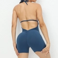 Navy blue one-piece yoga jumpsuit with backless halter design and peach butt contouring - Steel-Blue
