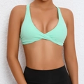 Mint green twist front sports bra yoga top paired with black leggings for fitness - Verdant