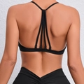 Women's black quick-dry sports bra featuring a multi-strap cross back design - M / Black