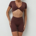 Women's dark brown yoga set featuring a V-neck twist short sleeve top and high waist shorts - S / Coffee