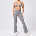 Detail view of grey twisted sports bra and flared yoga pants high-stretch gym set - S / Dark Gray
