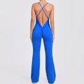 Detail view of the criss-cross back straps and scrunch butt design on blue flared jumpsuit - S / Royal Blue