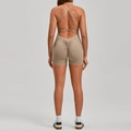 Close-up of khaki backless yoga jumpsuit featuring scrunch butt detail and cross straps - Clay Brown