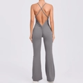 Detail view of dark grey yoga jumpsuit featuring criss-cross back straps and ruched butt lifting - S / Dark Gray