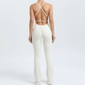 Creamy white backless flared yoga jumpsuit with thin cross straps and scrunch butt detail - S / Beige