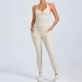 Creamy white halter yoga jumpsuit with side pockets and crisscross open back design - Beige