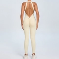 Beige backless yoga jumpsuit with ruched peach lift design and deep V back straps - Beige