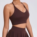 Dark brown yoga set featuring a V-neck sports bra and pleated high-waisted tennis skirt - Coffee