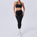 Set yoga nero due pezzi con reggiseno sportivo incrociato e leggings a vita alta aderenti - S / Nero