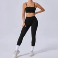 Women's black seamless yoga set featuring a strappy sports bra and high waisted leggings - S / Top And Bottom / Black