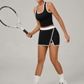 Dames tennisset in zwart met een contrast sporttop en bijpassende korte sportrok - S / Zwart