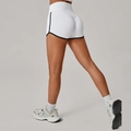 Pantaloncini da yoga bianchi a vita alta con effetto scrunch e profili neri a contrasto - S / Bianco